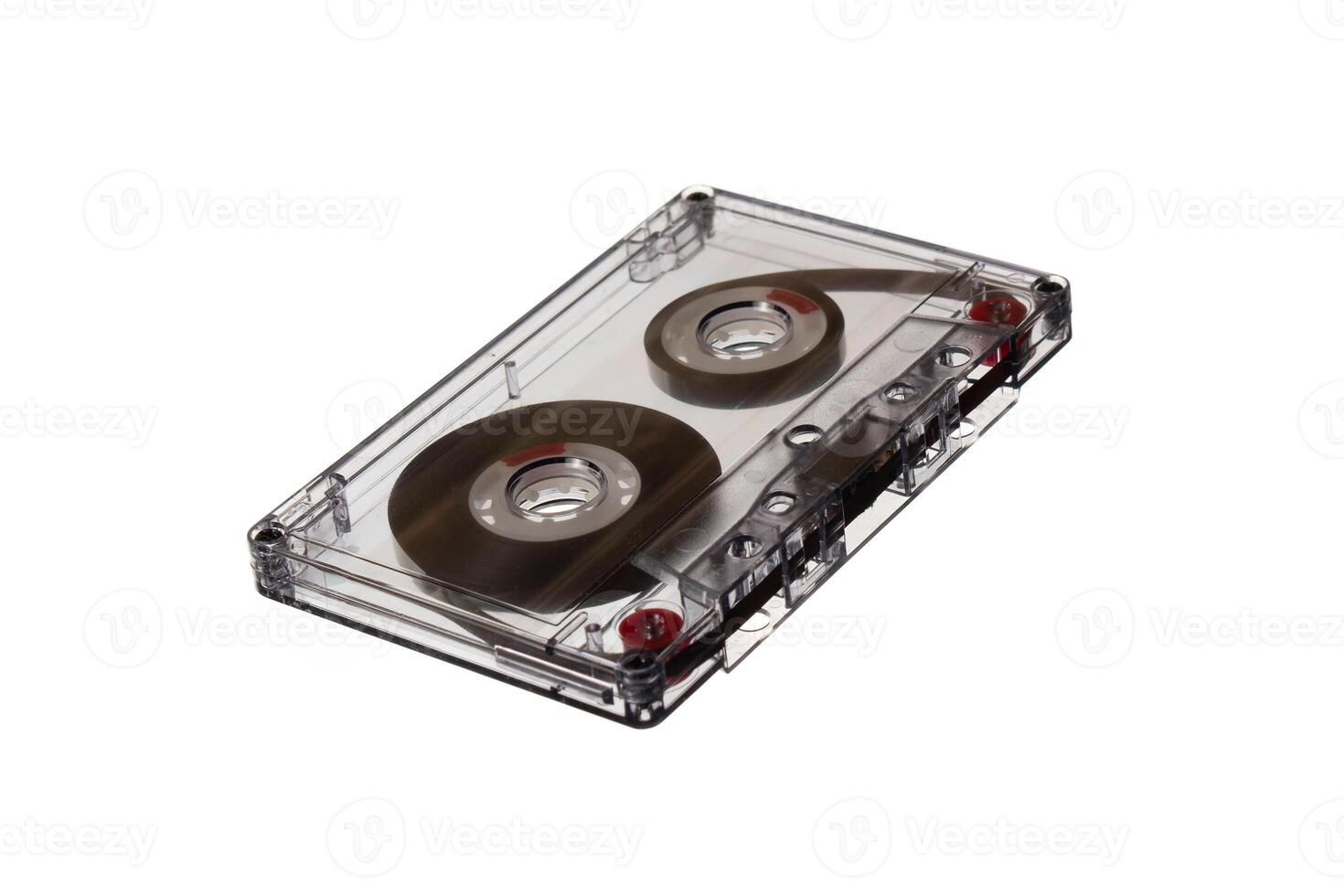 Clear plastic audio cassette tape with visible reels and magnetic tape, isolated on a white background. photo