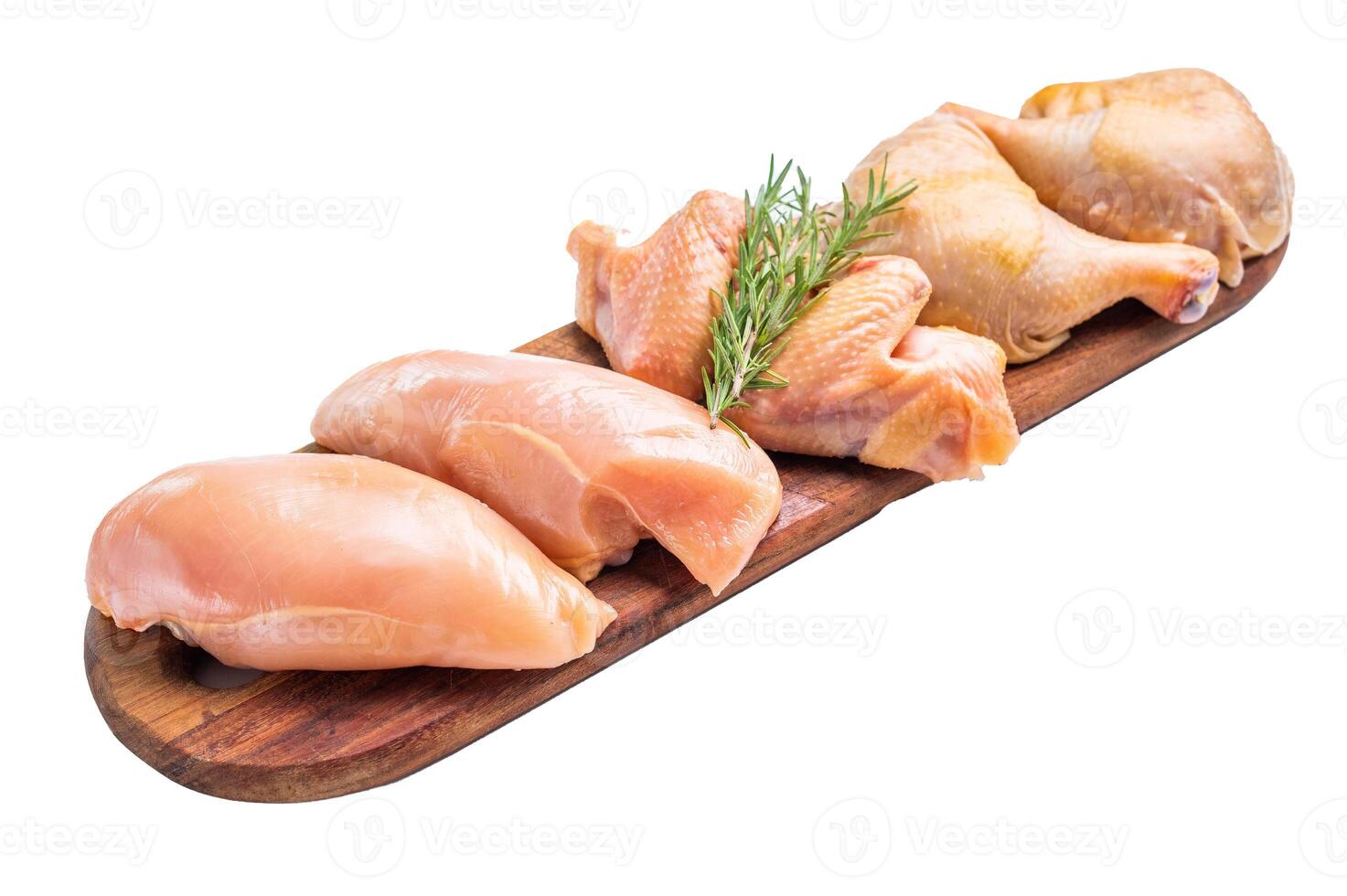Fresh, raw chicken breasts and legs on a wooden board, isolated on white background photo