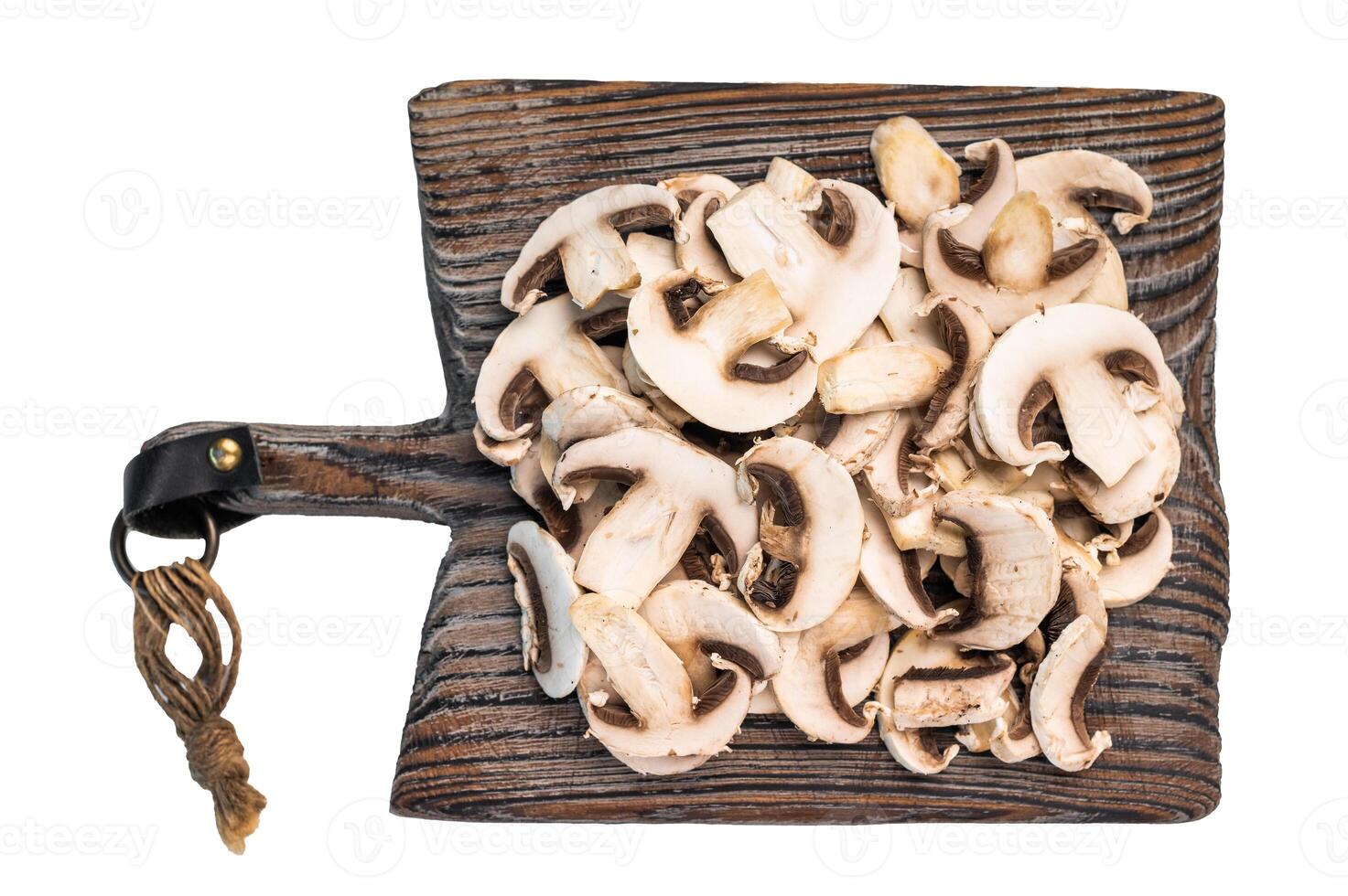 Raw Sliced champignons Mushrooms on a wooden cutting board isolated on white background. photo