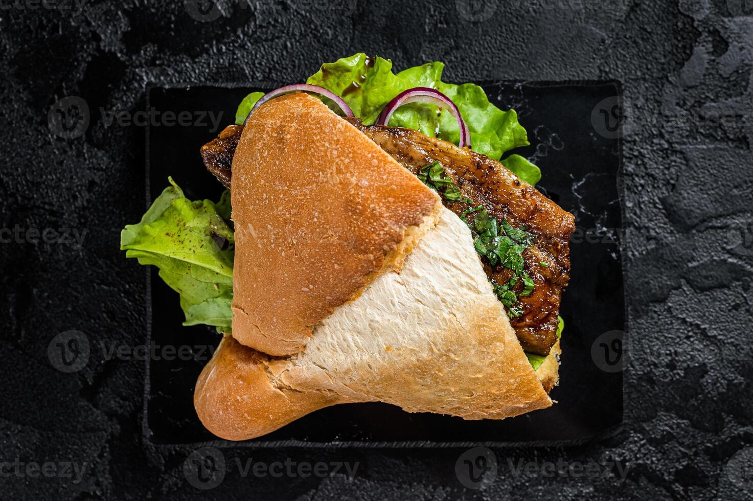 Turkish fish sandwich with grilled mackerel fillet Balik Ekmek. Black background. Top view photo