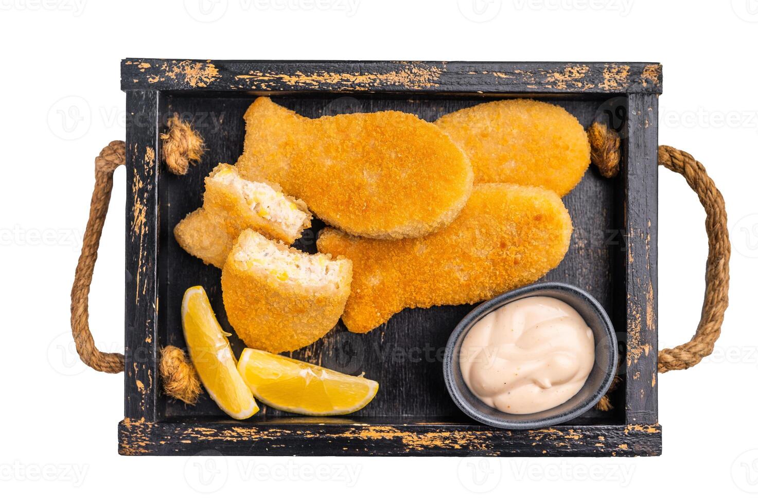 Crusted Fish sticks fingers with lemon and tartar sauce in wooden tray isolated on white background. top view photo
