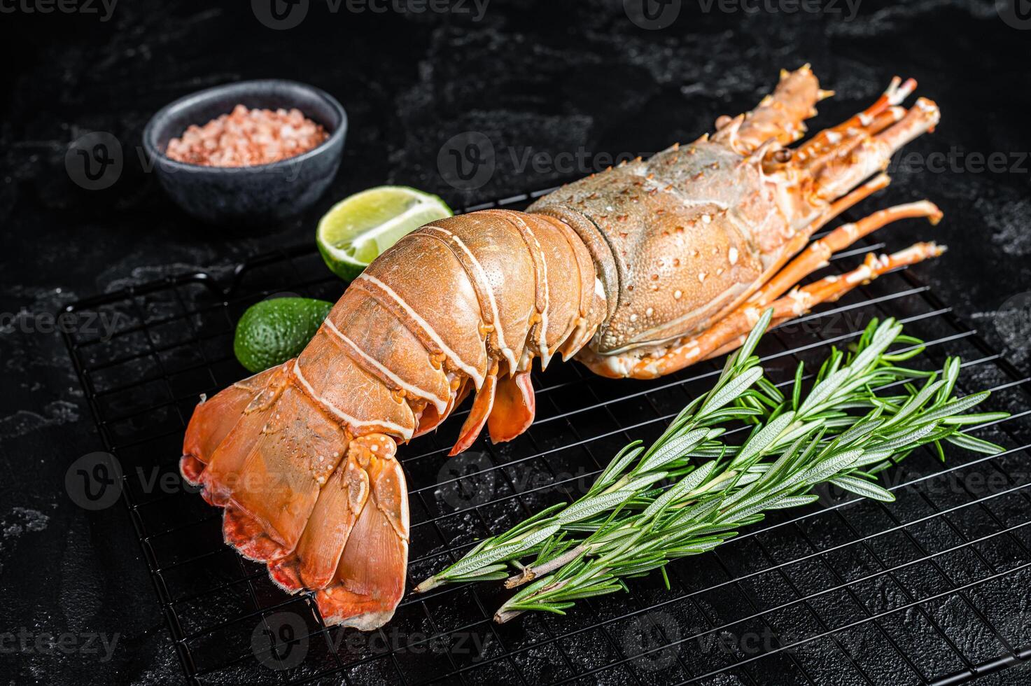 Boiled Spiny lobster or sea crayfish ready for eat. Black background. Top view photo