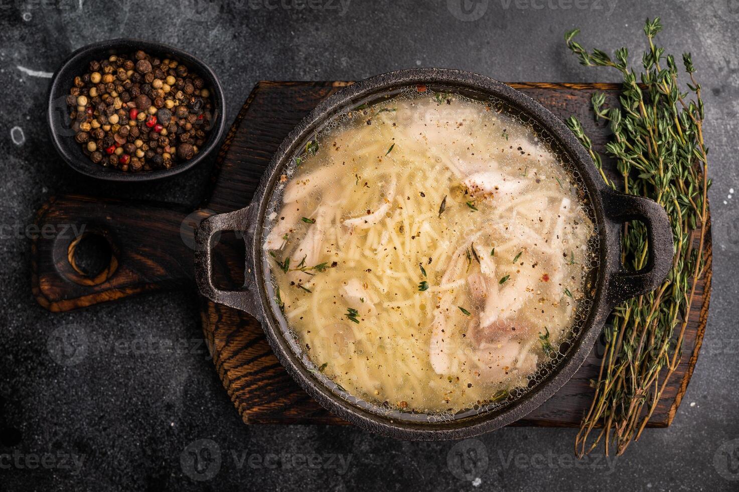 Chicken noodle soup with Vermicelli and meat in a bowl. black background. top view photo
