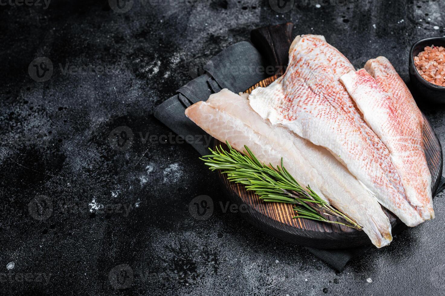 Fresh Raw red perch fillet, Snapper fish on a wooden board. Wooden background. Top view. Copy space photo