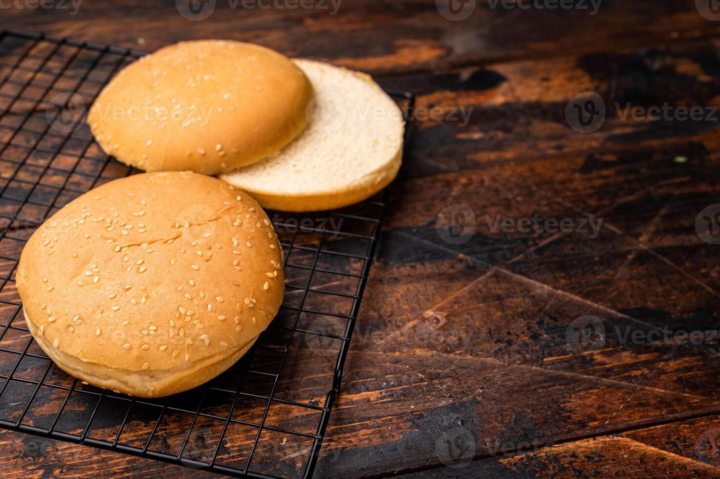 Fresh Baked burger buns, bread for cooking hamburgers. wooden background. top view photo