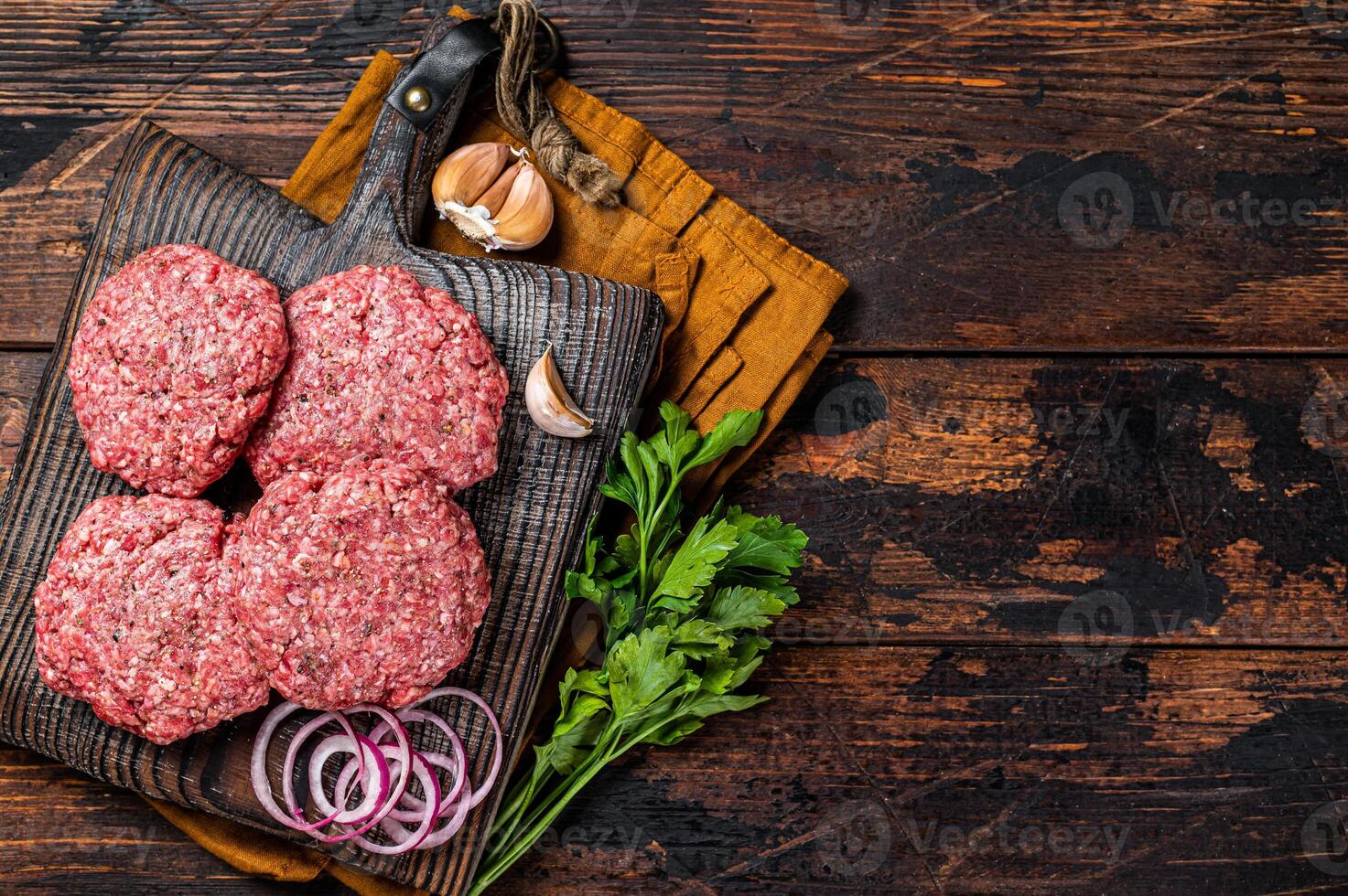 Fresh Raw burger patty, mince beef Meat, uncooked meat cutlets. Wooden background. Top view. Space for text photo