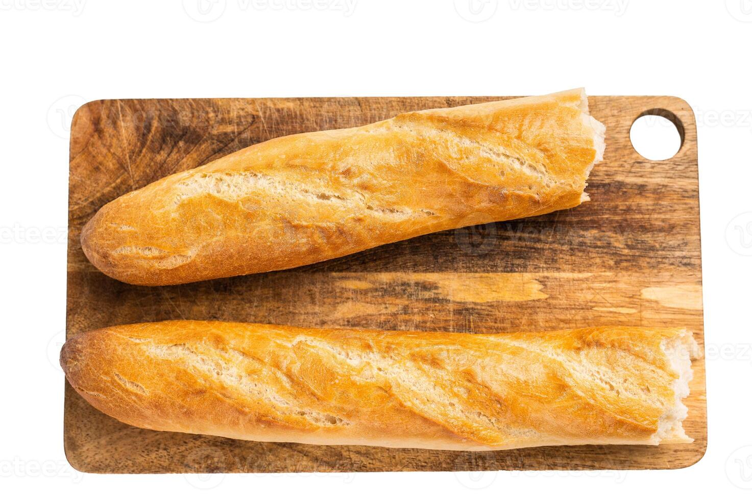 French bread baguette on wooden cutting board isolated on white background. top view photo