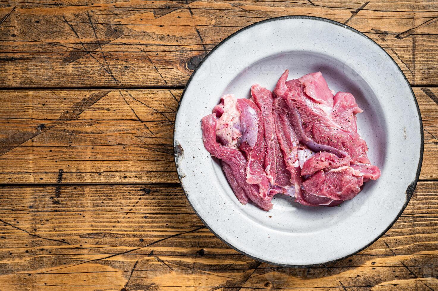 Pieces of raw turkey thigh, Poultry fresh meat. Wooden background. Top view. Space for text photo