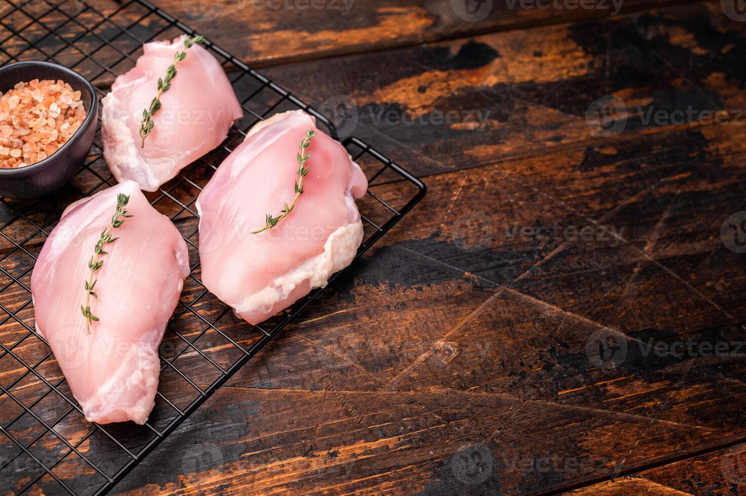 Raw Skinless boneless chicken thighs fillet. wooden background. top view photo