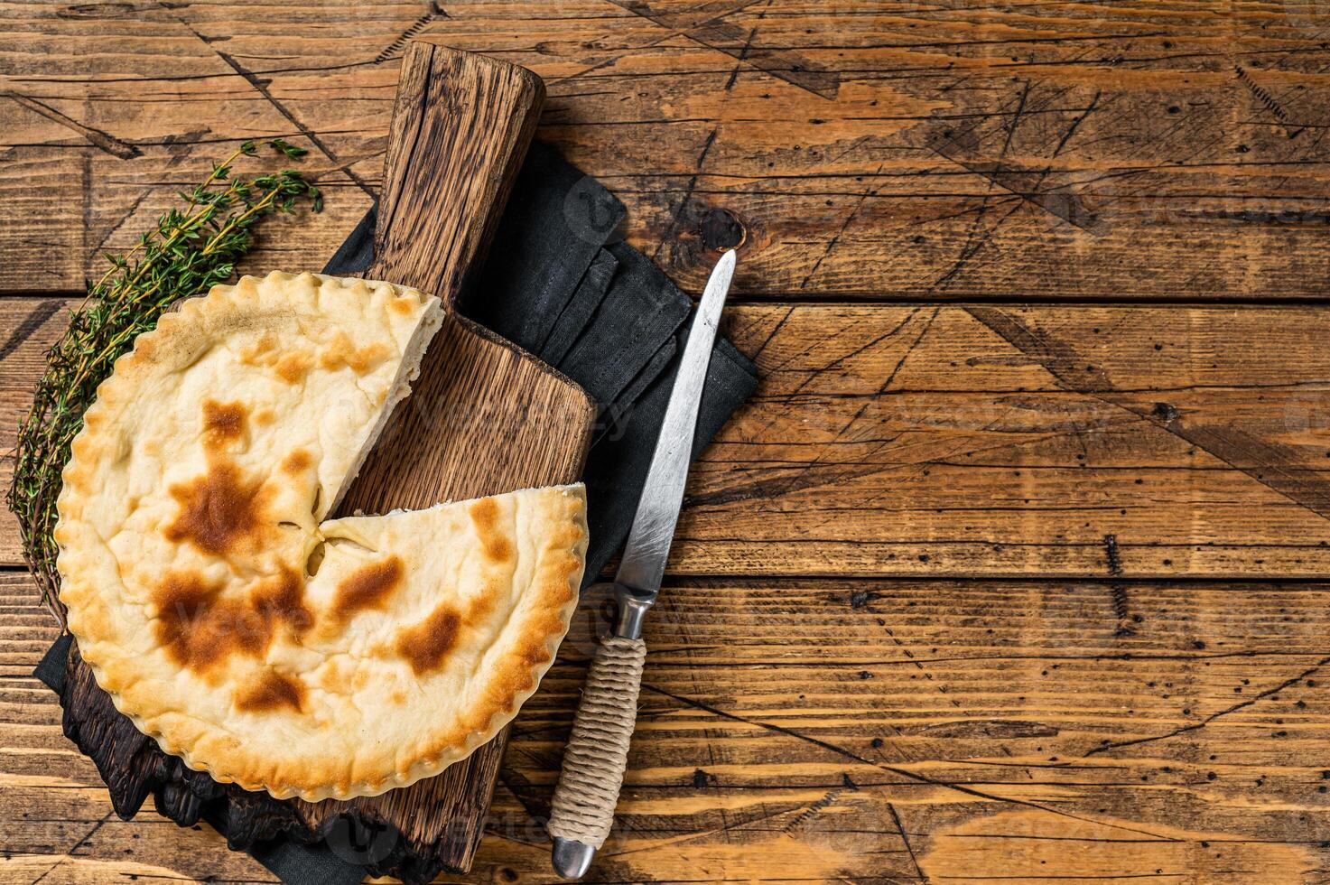 Kubdari Bread, Tasty Flat Bread Stuffed with Spiced meat. Wooden background. Top view. Copy space photo