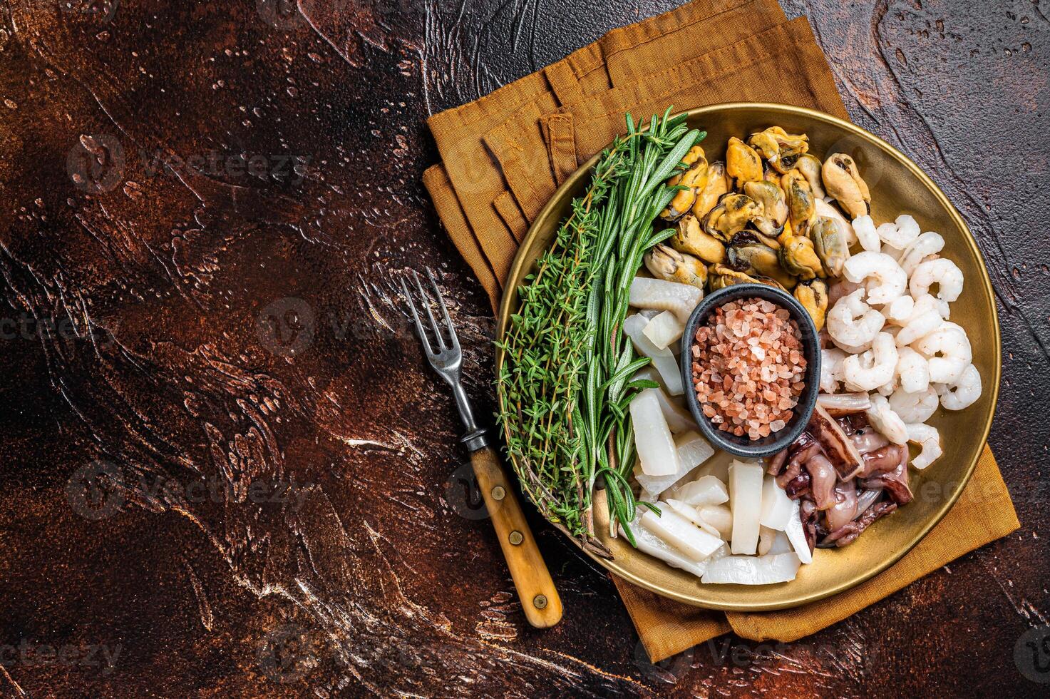 Seafood platter, mix of mussels, clams, squid, octopus, shrimps and prawn. Dark background. Top view. Copy space photo
