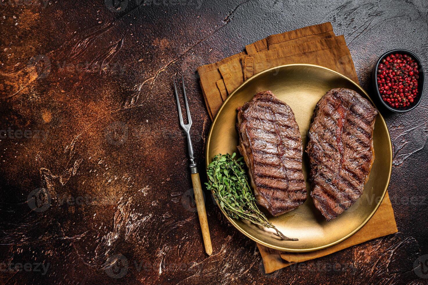 Grilled Shoulder Top Blade or Australia wagyu oyster blade beef steak. Dark background. Top View. Copy space photo