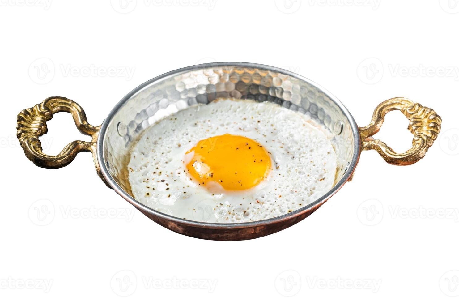 Breakfast with fried egg in a skilet with tomatoes and bacon. Isolated on white background. Top view. photo