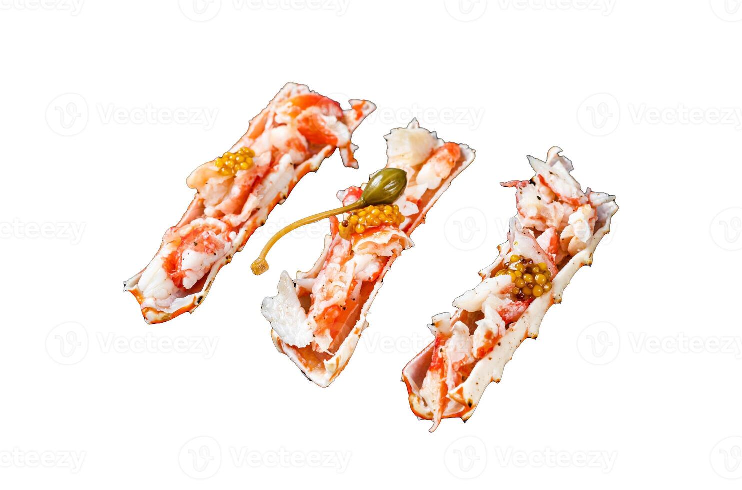 Crab leg meat in a sheel with herbs. Black background. Top view photo