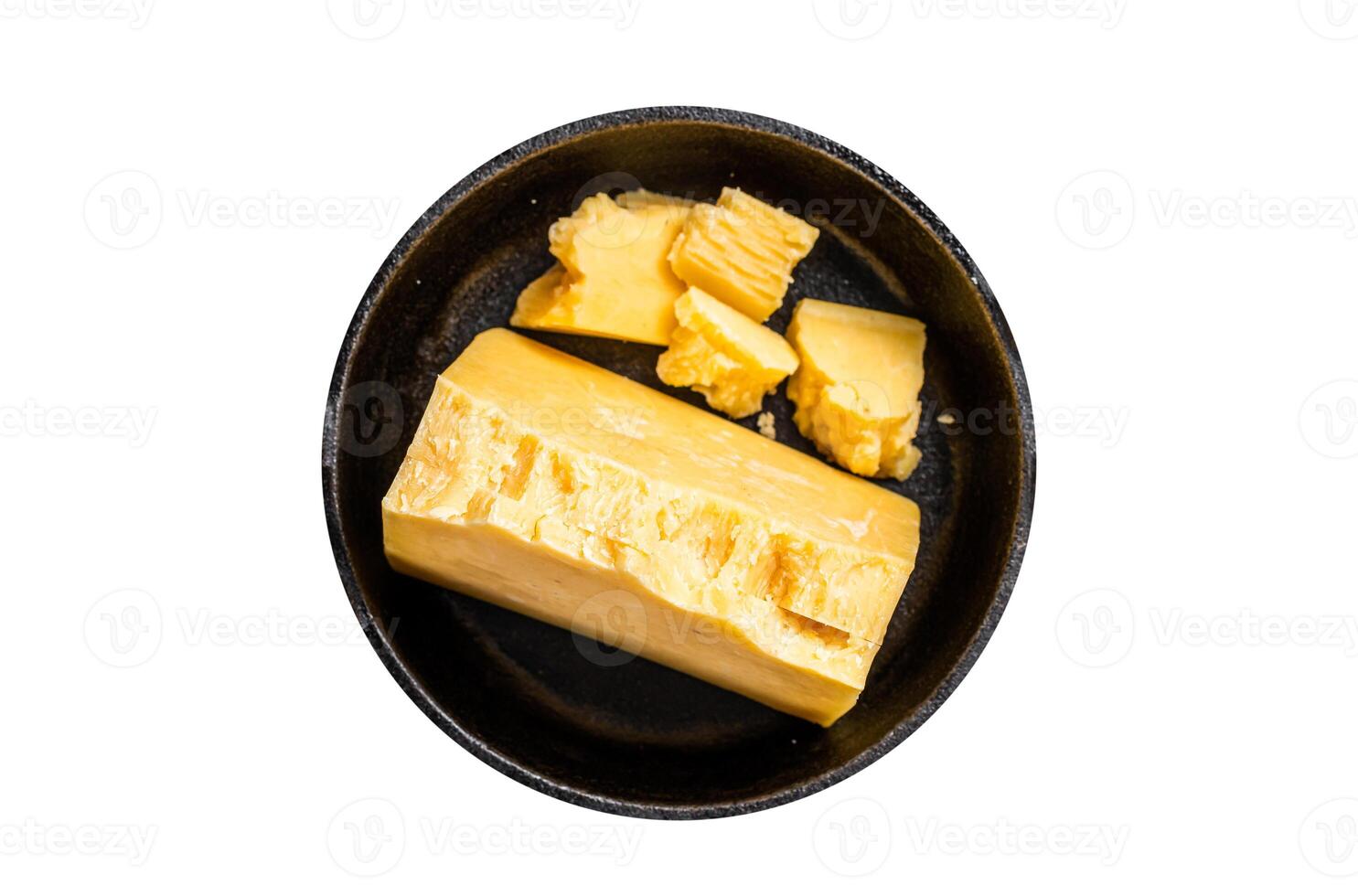 Parmesan hard cheese piece in a pan. Isolated, white background. Top view. photo
