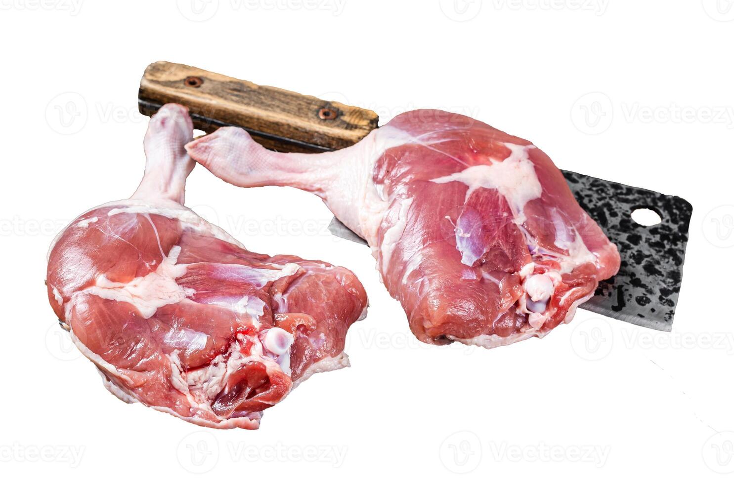Raw duck legs with spices and chef cleaver on a wooden board. Isolated, white background. photo