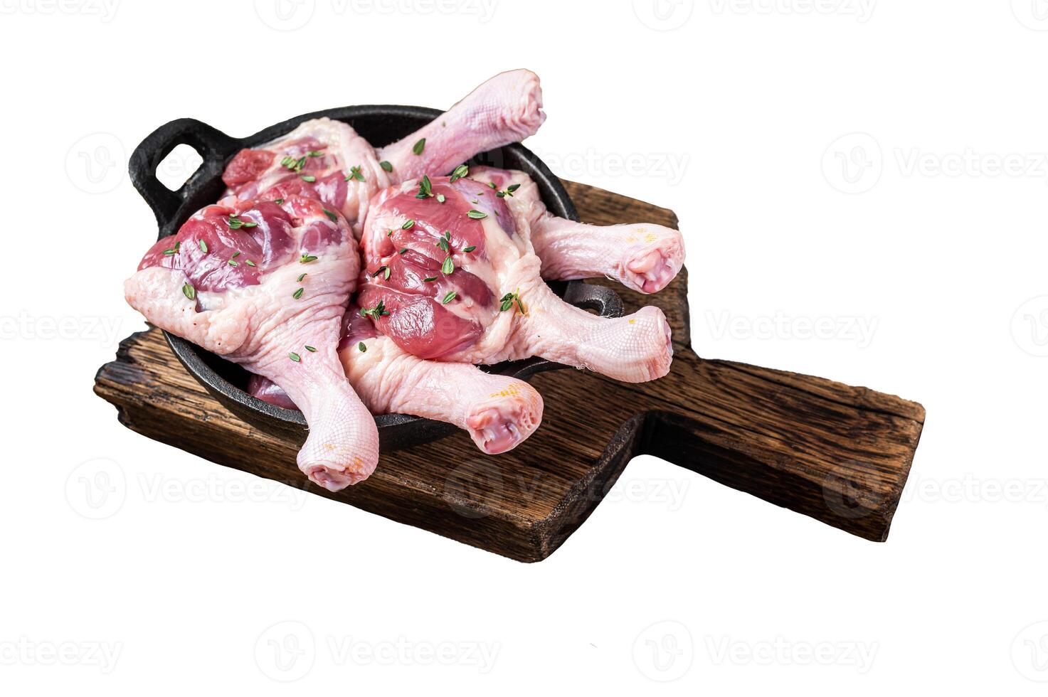 Raw Duck drumsticks in a pan with herbs. Isolated on white background, top view. photo