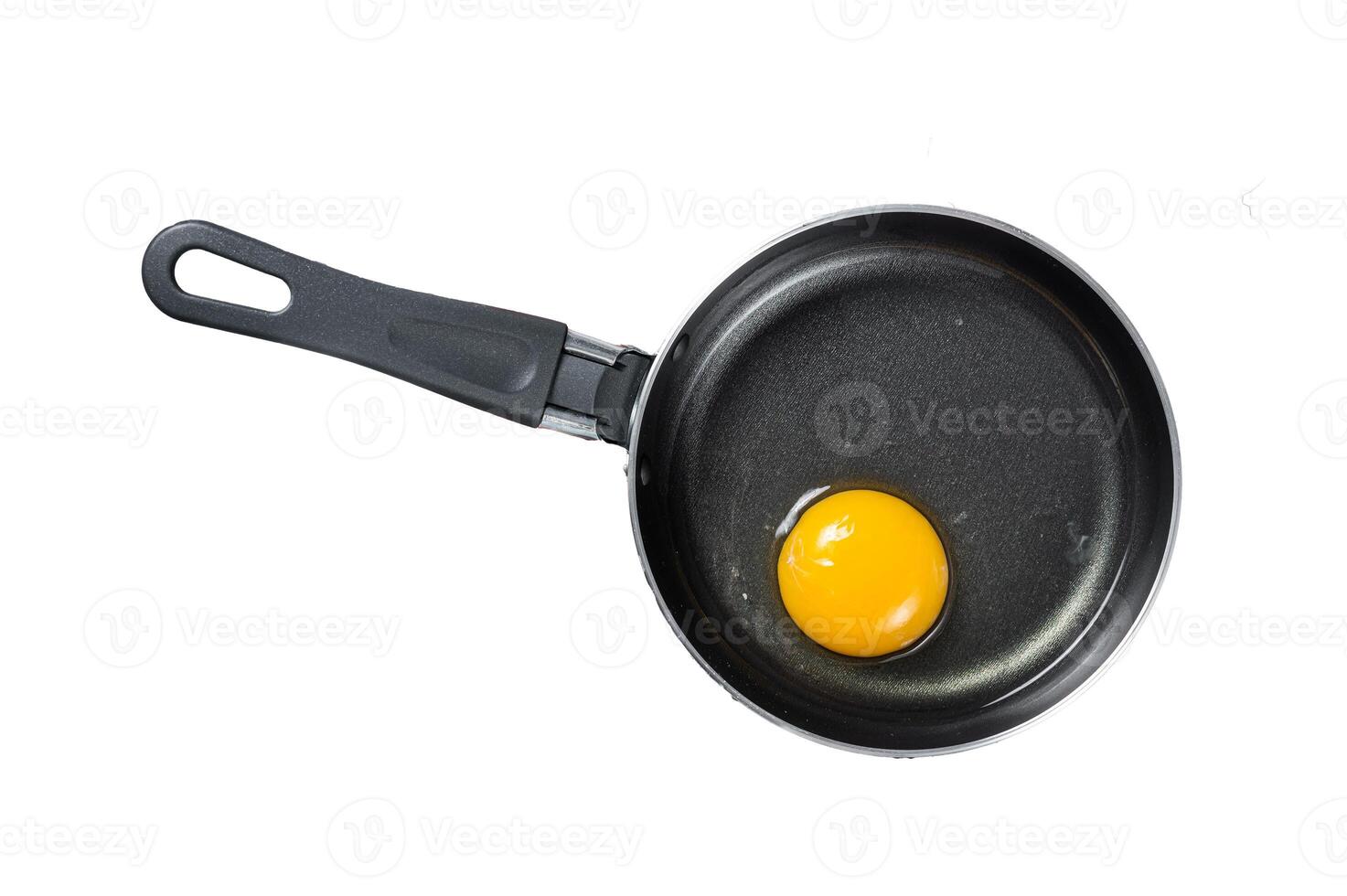 Cooking fried Egg in a skillet with bacon and tomato. Isolated, white background. photo