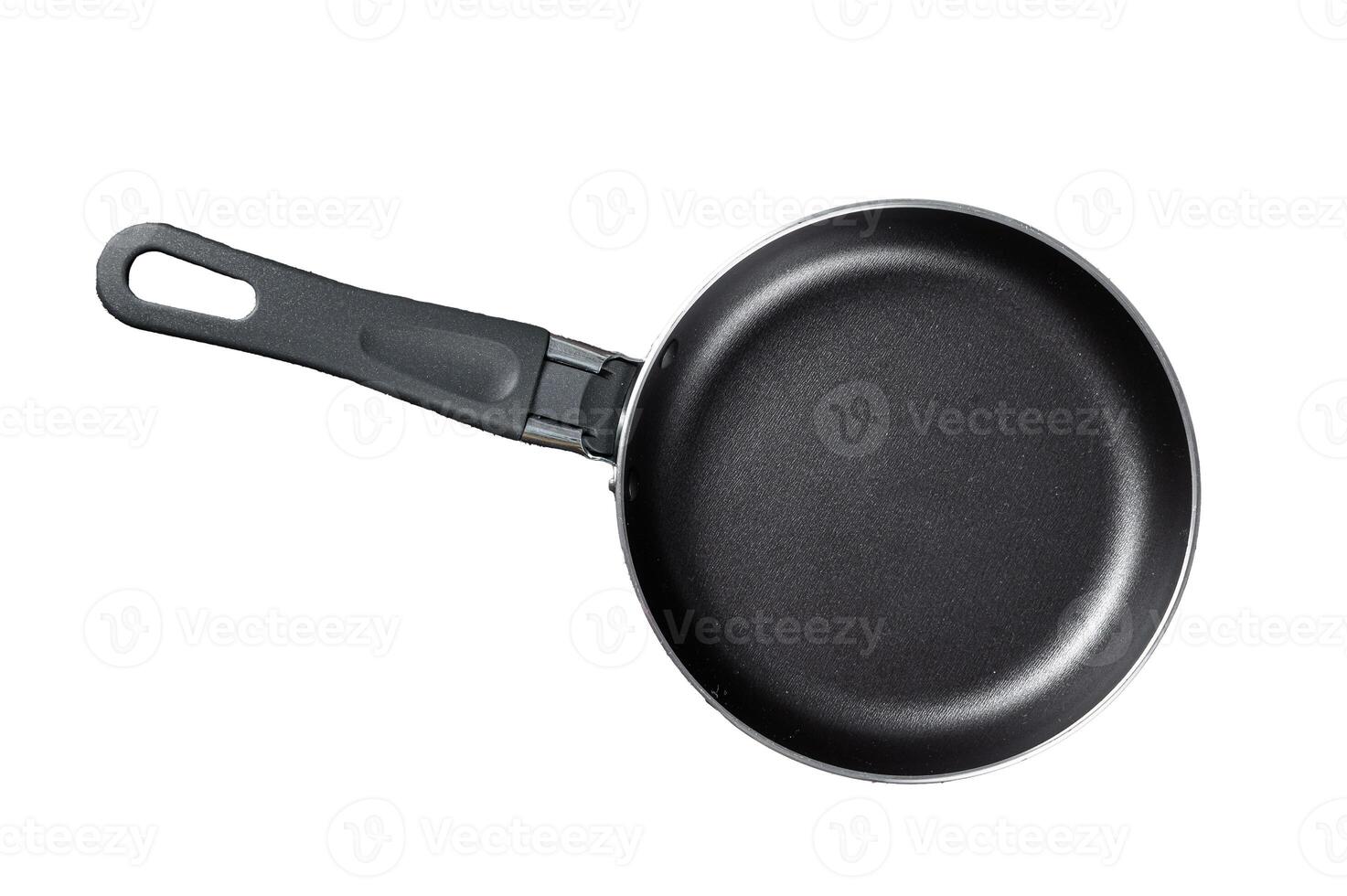 Empty iron frying pan on rustic table. Isolated, white background. photo
