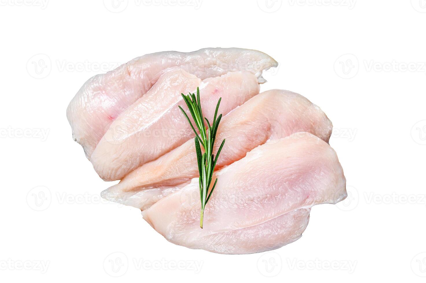 Raw sliced chicken breast fillet steaks on a marble board. Isolated on white background. photo