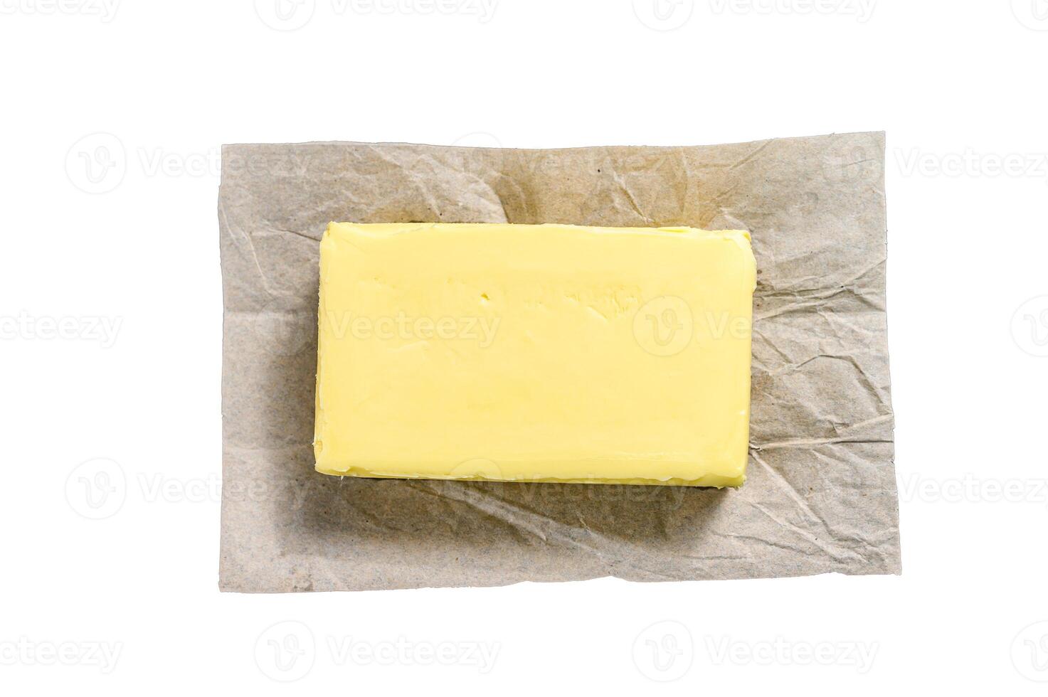 Butter on craft paper, dairy farm products. Isolated on white background. photo