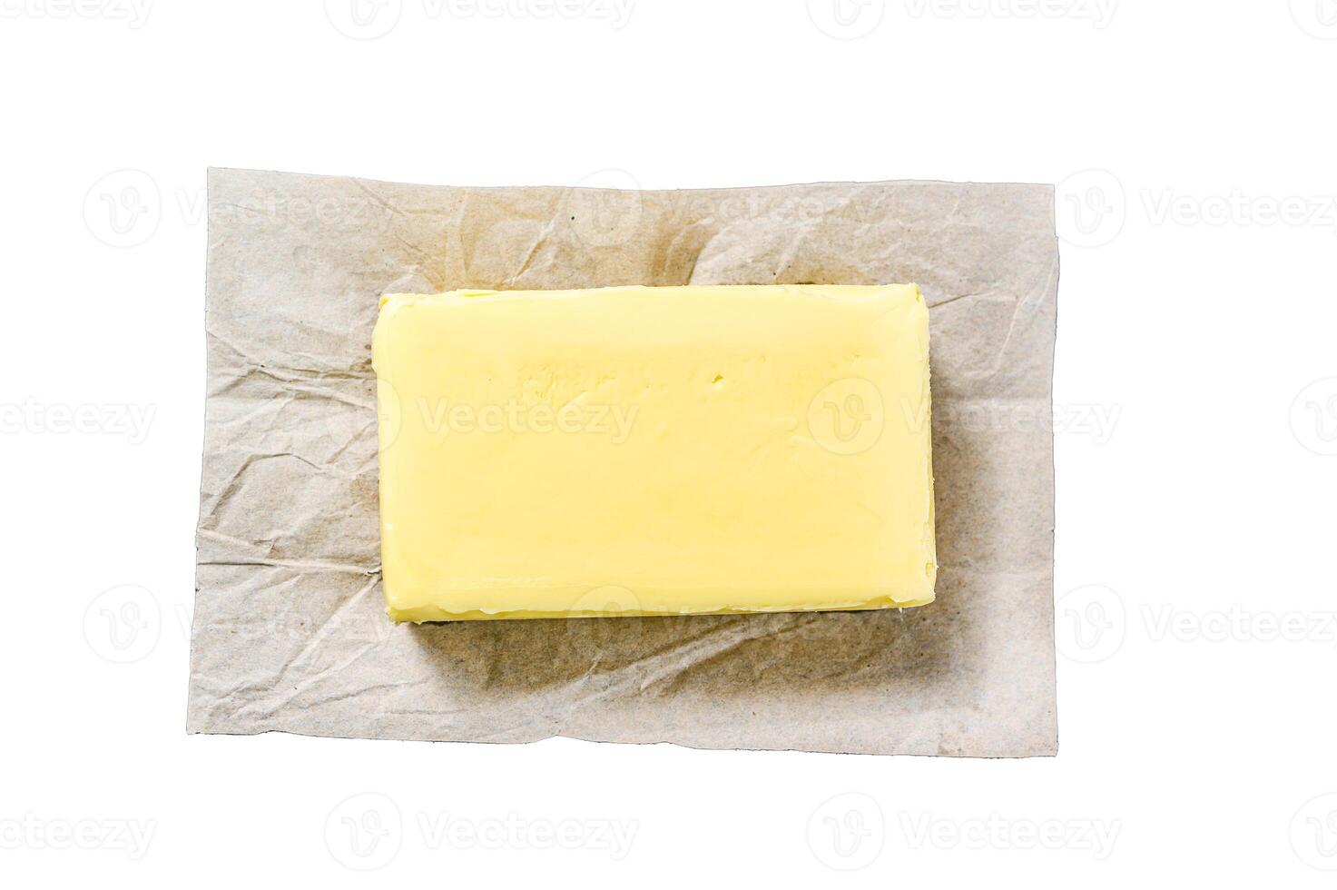 Butter on craft paper, dairy farm products. Isolated on white background. Top view. photo
