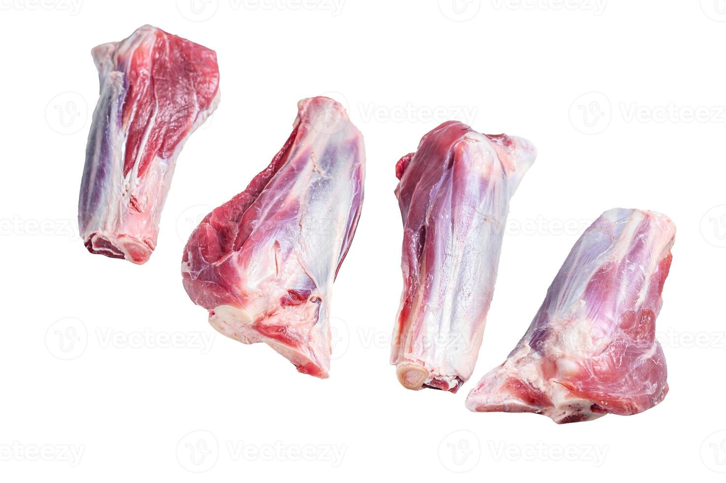 Raw lamb shanks meat on stone table. Isolated on white background. photo