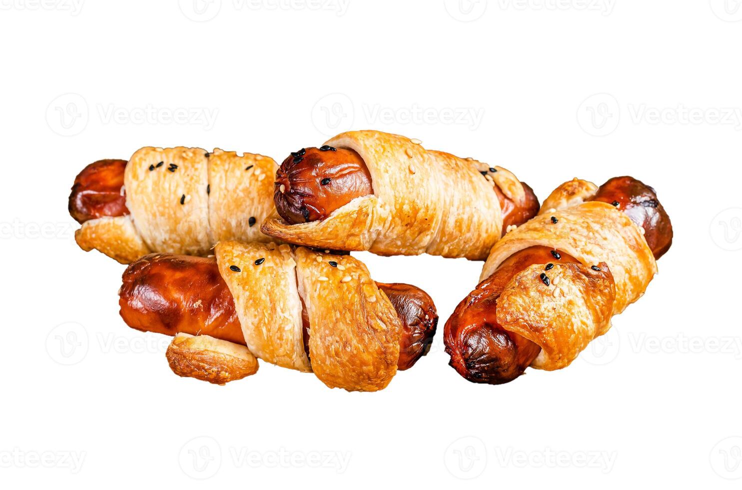 Rolled hot dog sausages baked in puff pastry with ketchup. Isolated, white background. photo