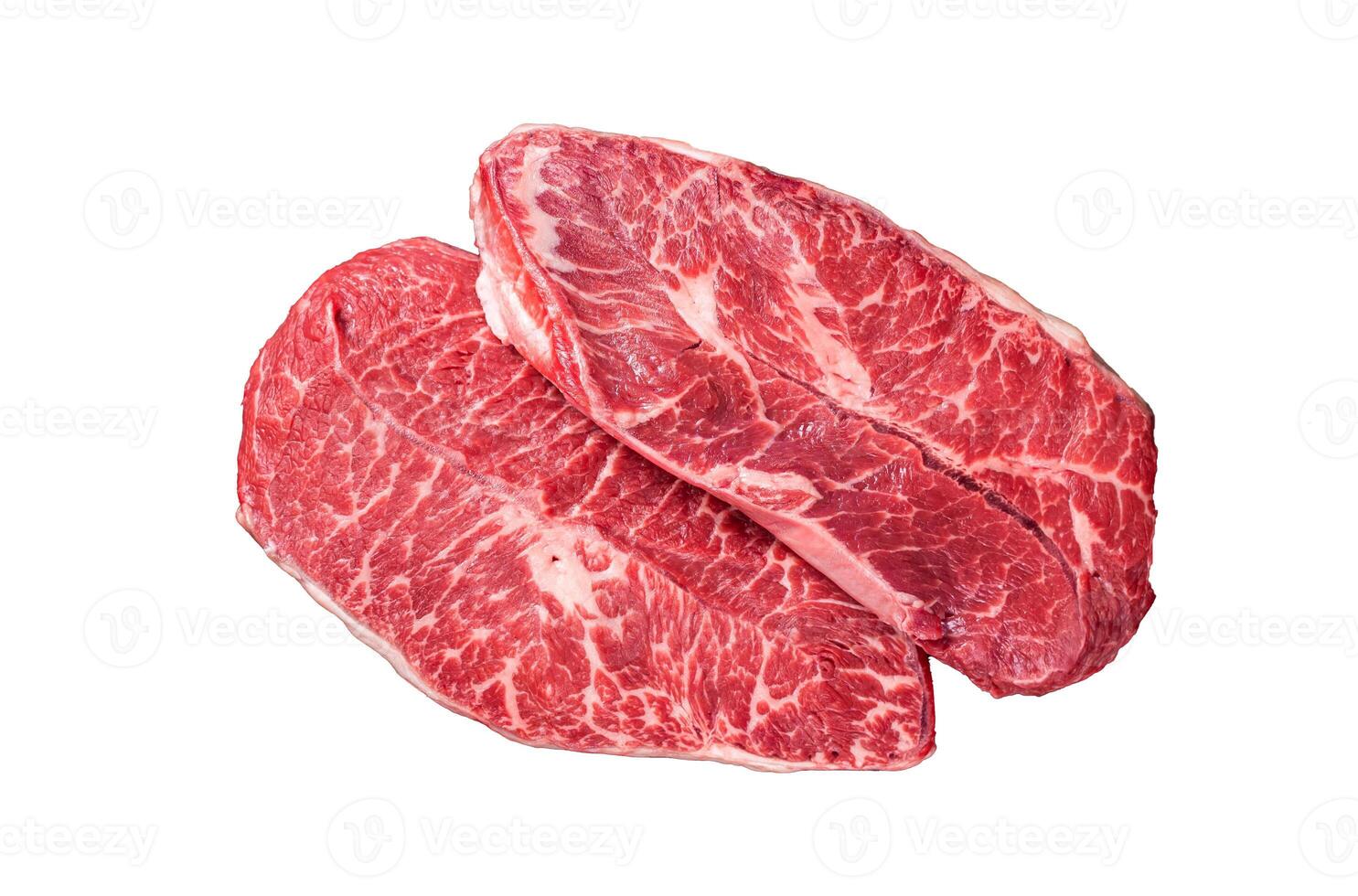 Uncooked Raw Shoulder Top Blade or flat iron beef meat steaks on a wooden butcher board with meat cleaver. Isolated, white background. photo