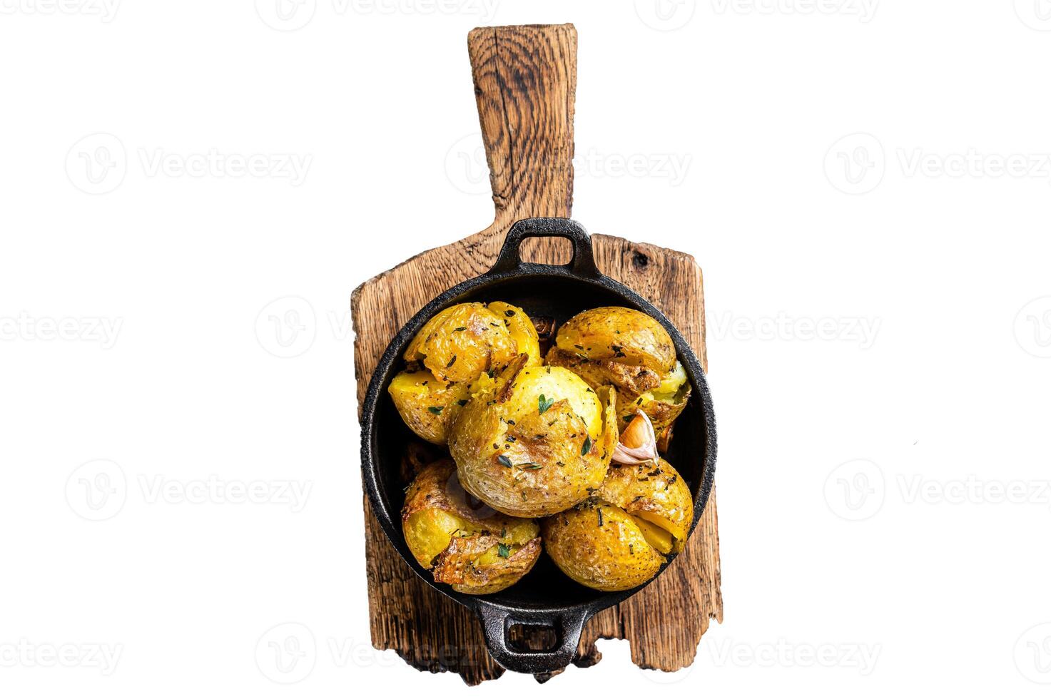 Crushed, Broken potatoes baked in oil with herbs. Isolated, white background. photo