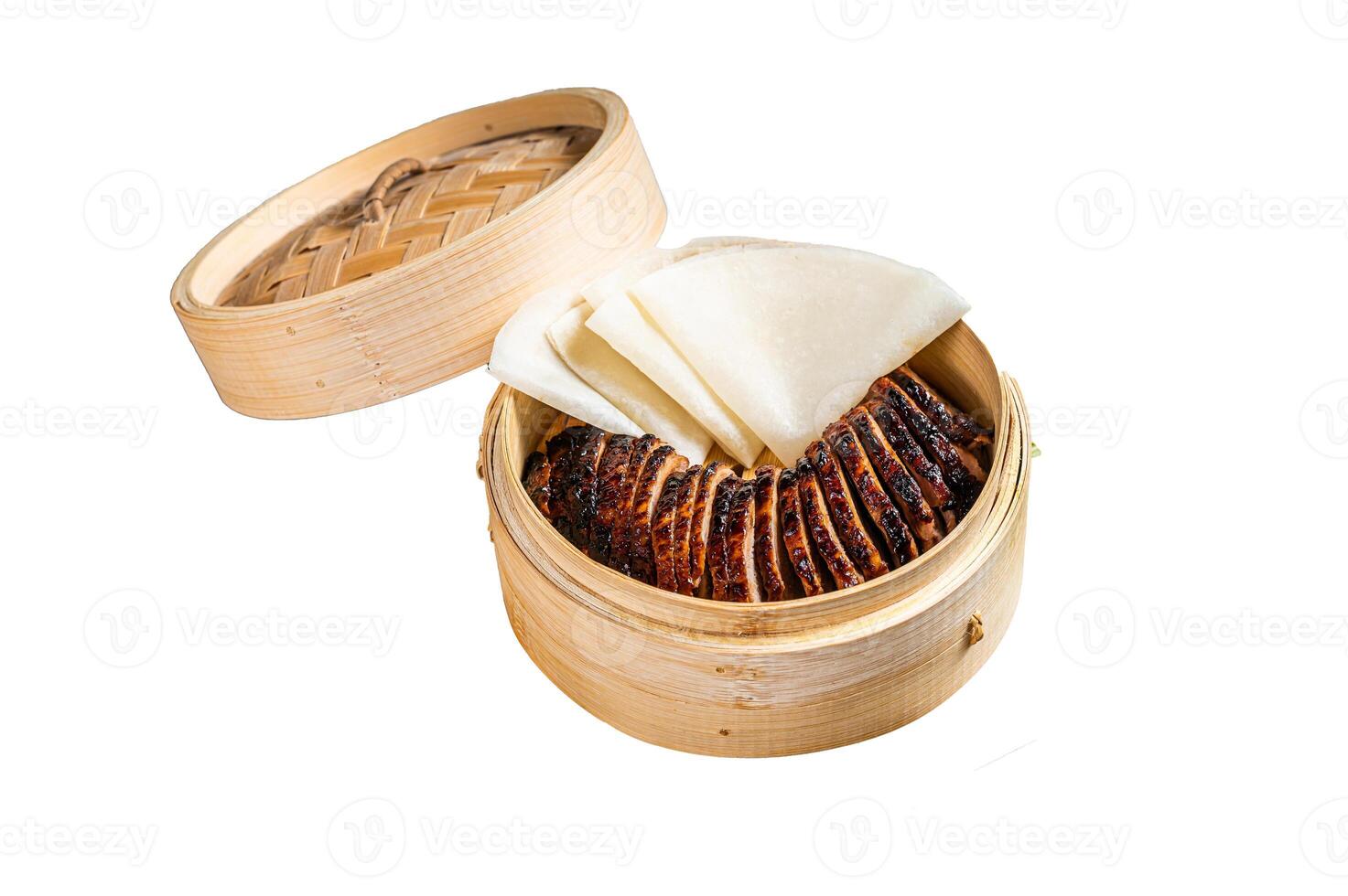 Peking Duck in bamboo steamer served with cucumber, green onion, and wheaten chinese pancakes and sauce Hoysin. Isolated on white background. Top view. photo