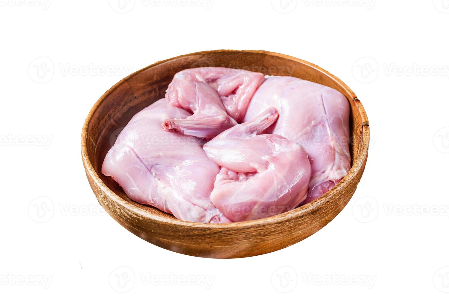 Rabbit legs uncooked in a wooden plate. Isolated on white background, top view. photo