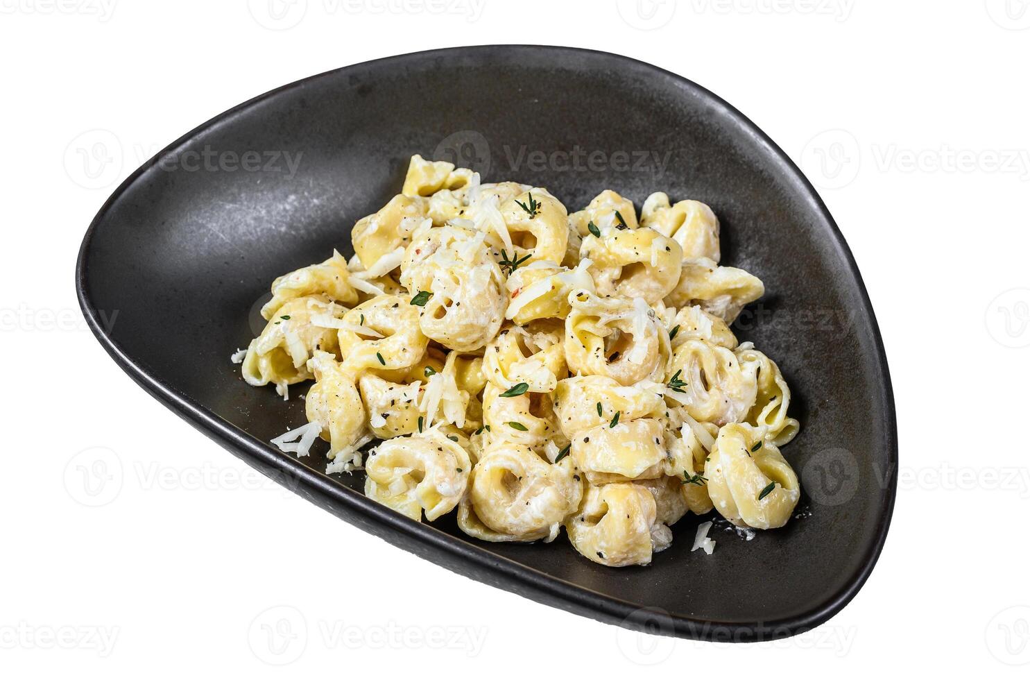 Italian tortellini pasta in cream sauce.with spinach. Isolated on white background, top view. photo