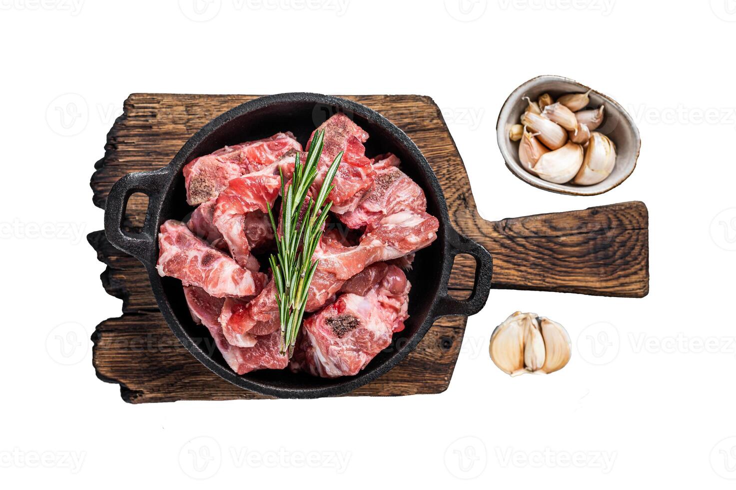 Raw diced meat cubes with bone in a pan. Isolated, white background. photo
