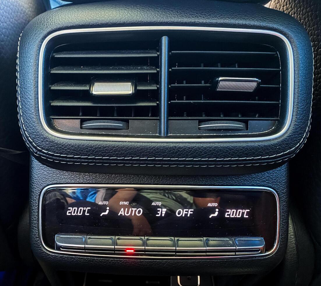 The modern car climate control panel boasts dual temperature settings along with adjustable air vents for optimal passenger comfort and convenience photo