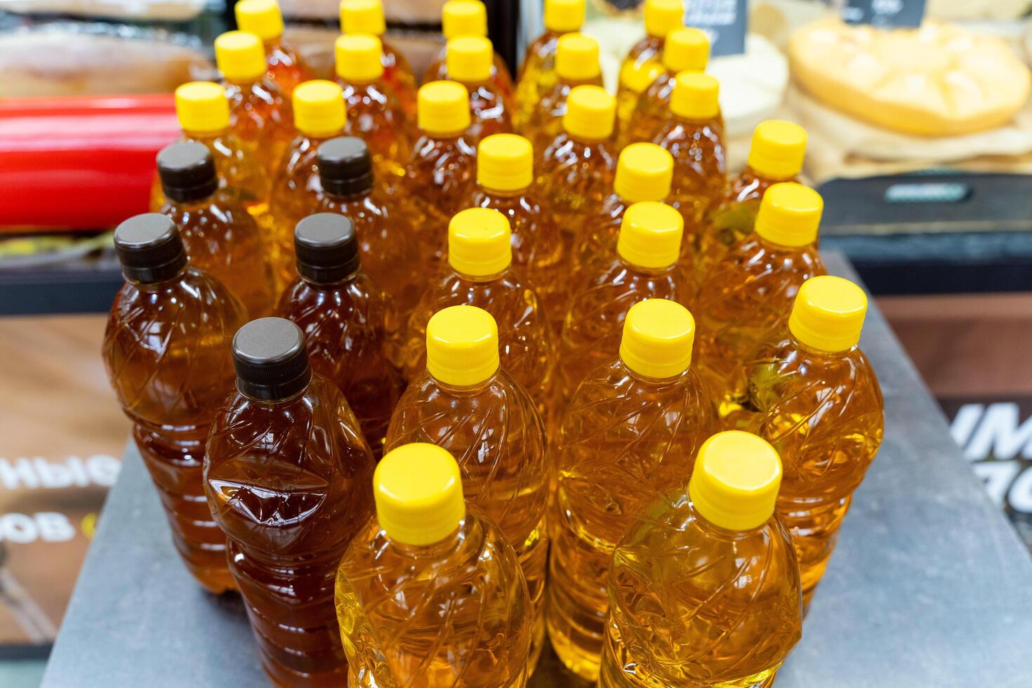 Plastic bottles with yellow caps arranged neatly on a table photo