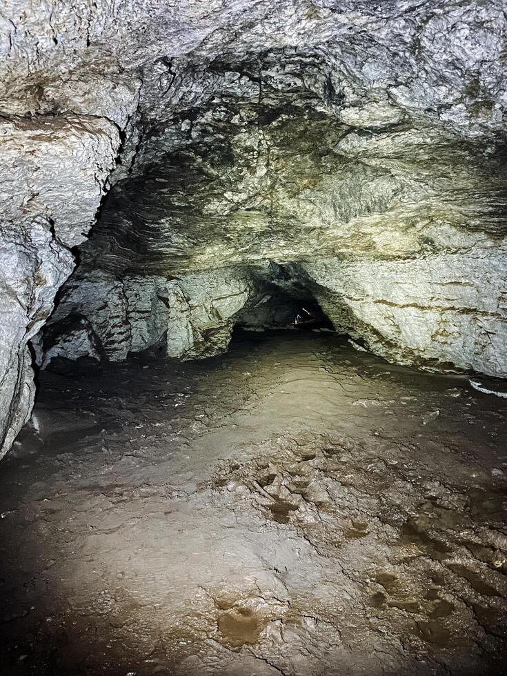 The entrance to a mysterious cave reveals stunning natural rock formations, where shadows play and adventure calls for exploration photo