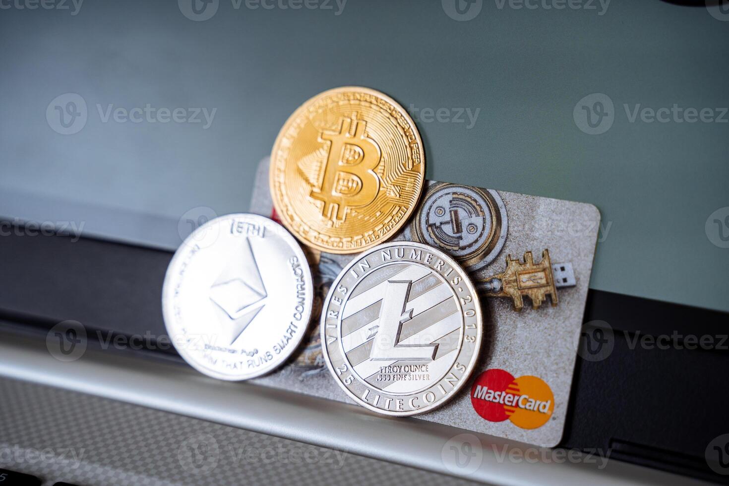 Bitcoin, litecoin, and ether on a credit card photo