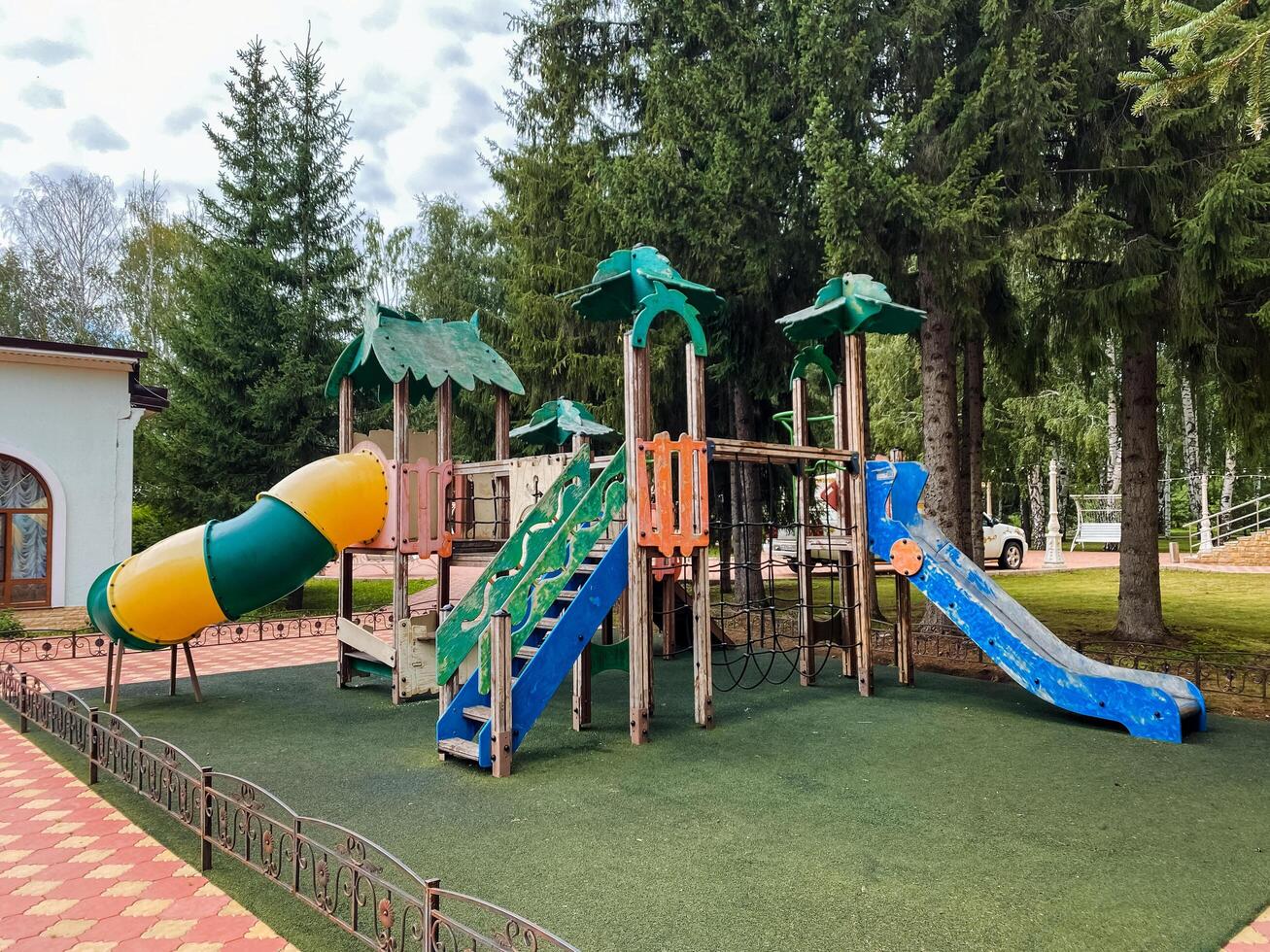 In a vibrant and lively playground setting, theres a brightly colored slide, robust climbing stairs, and a fun tunnel for kids to eagerly explore and enjoy numerous hours of outdoor fun photo