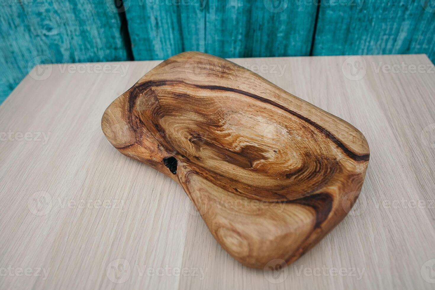A wooden bowl sitting on a table photo
