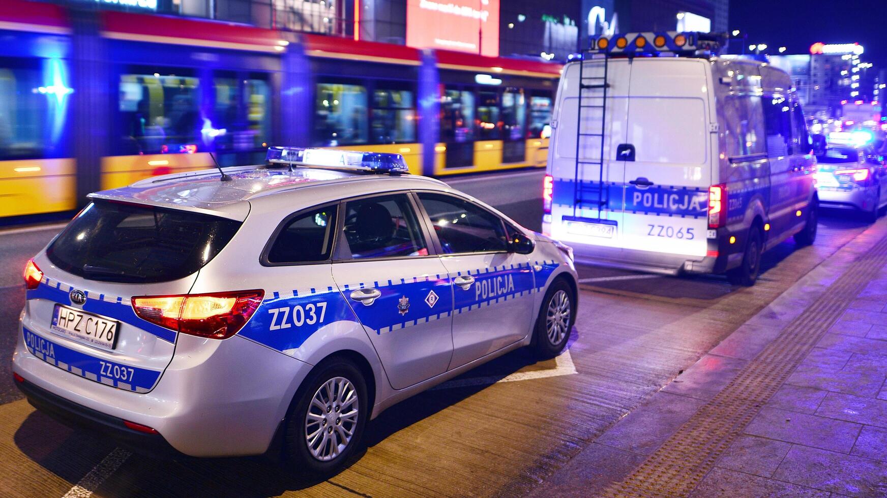 Warsaw, Poland. 22 November 2024. Police car on patrol with blue lights on the street in the night. photo