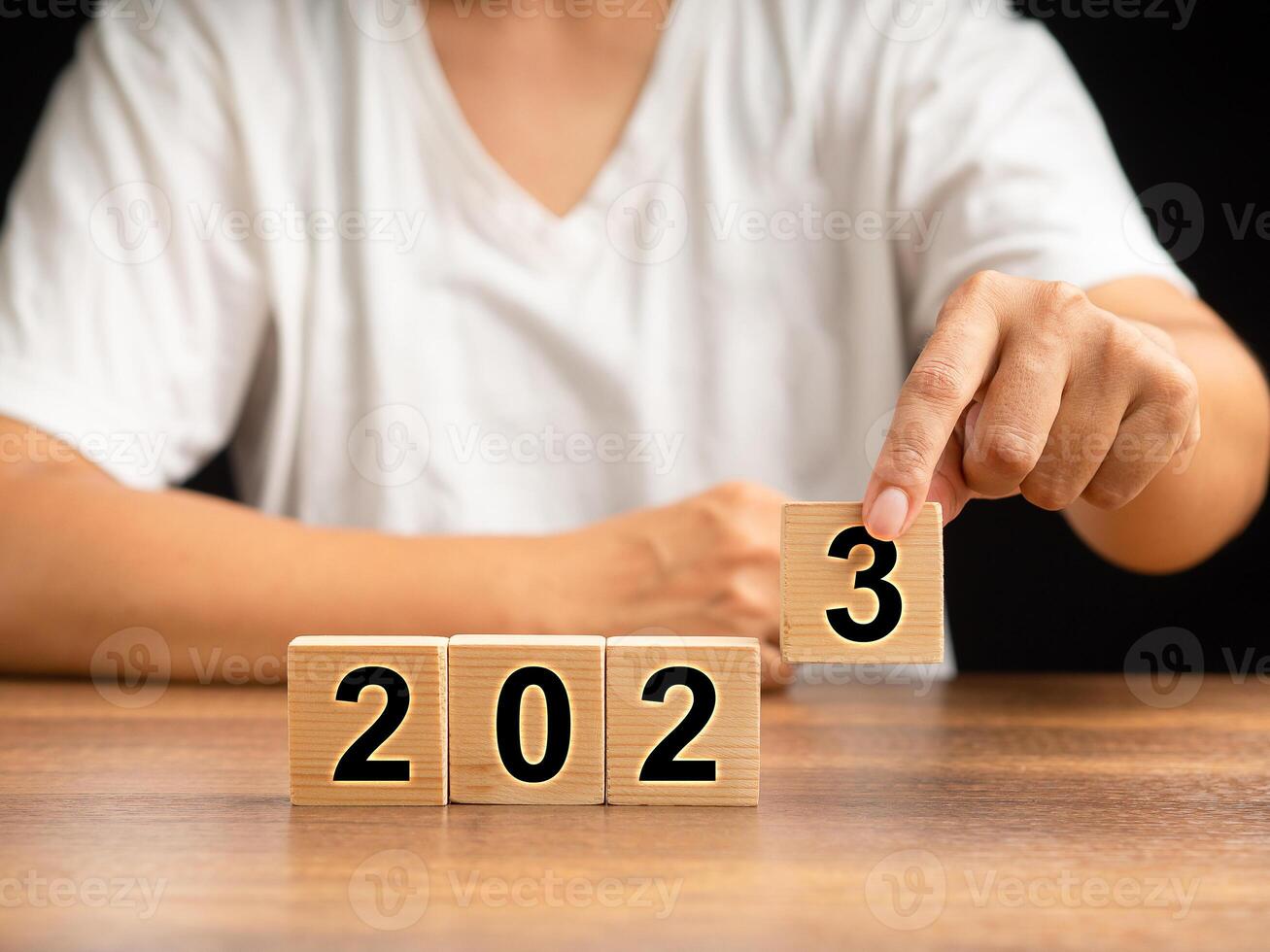 Business planning in 2023 concept. Hand holding a wooden cube with the letters 2023 photo
