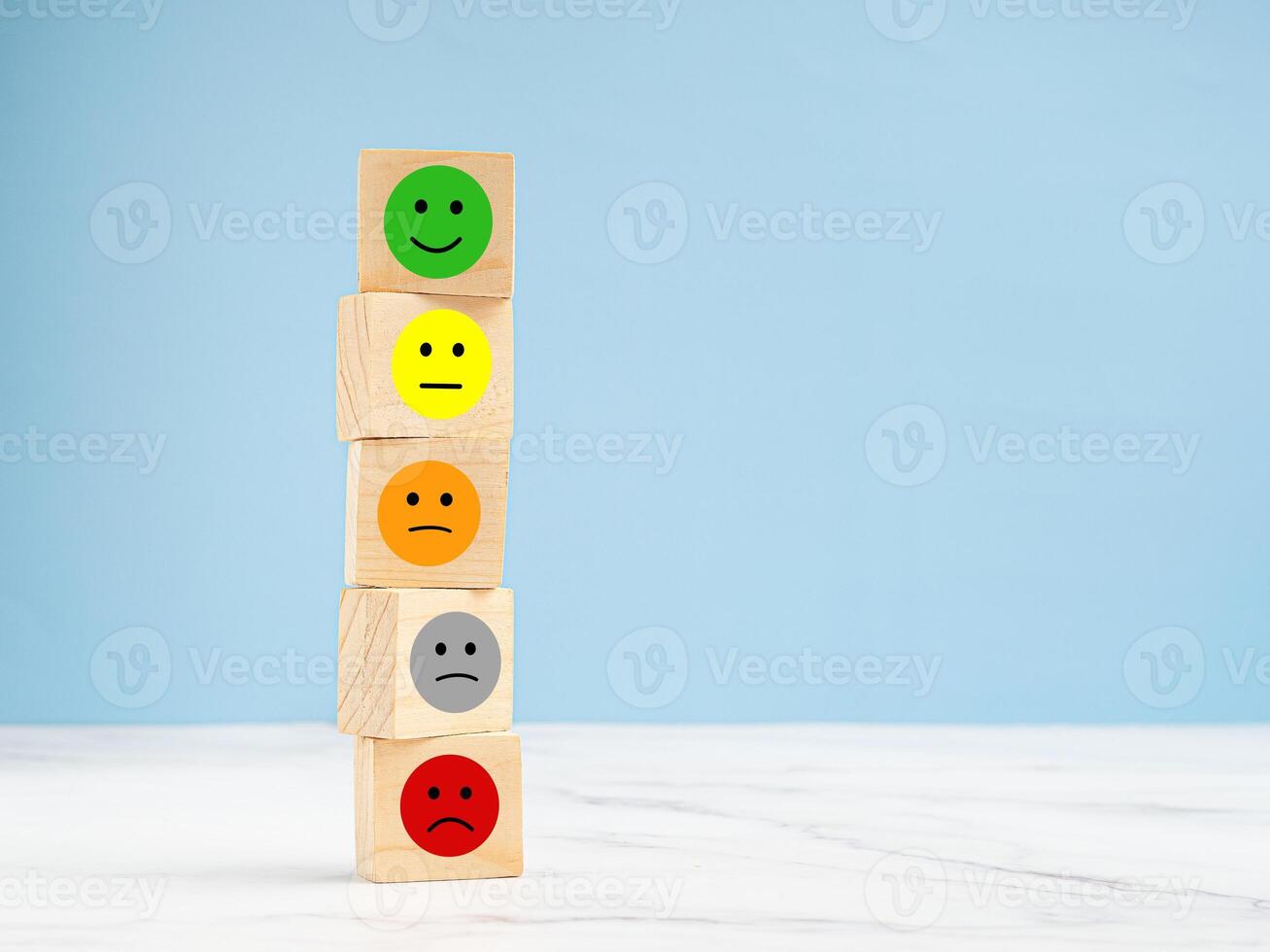 Customer feedback. Wooden cubes with the face icon give satisfaction to the service photo