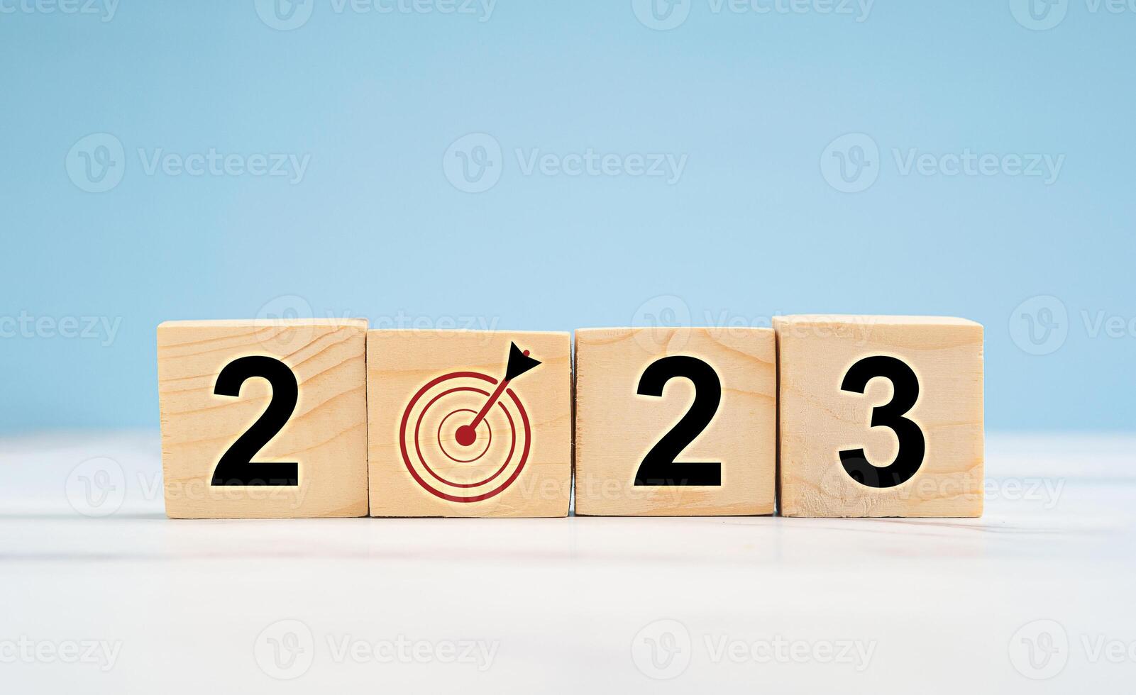 Business planning in 2023 concept. Wooden cubes with the letters 2023 and goal icon for business strategy photo
