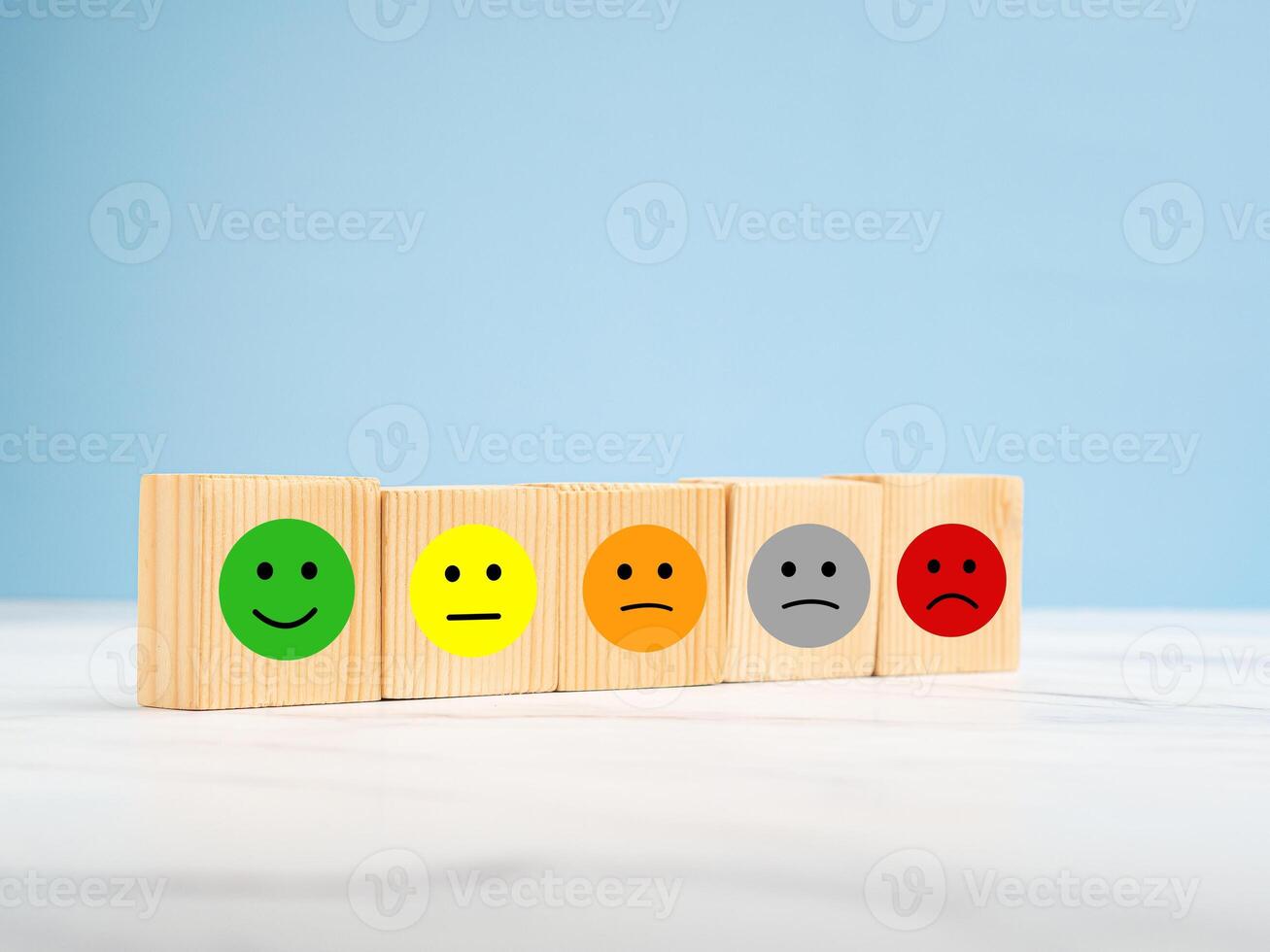 Customer feedback. Wooden cubes with the face icon give satisfaction to the service photo