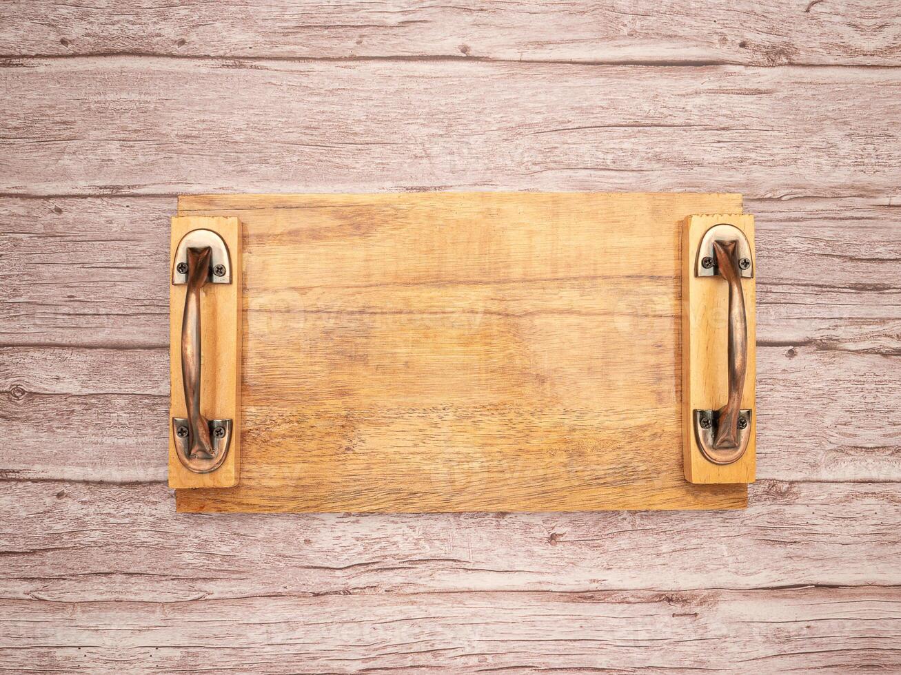 Top view of an empty wooden tray on a wooden table photo