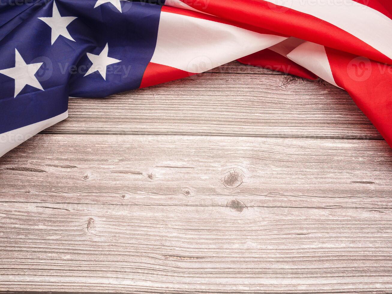 Top view of the American flag on a wooden table with copy space for text photo