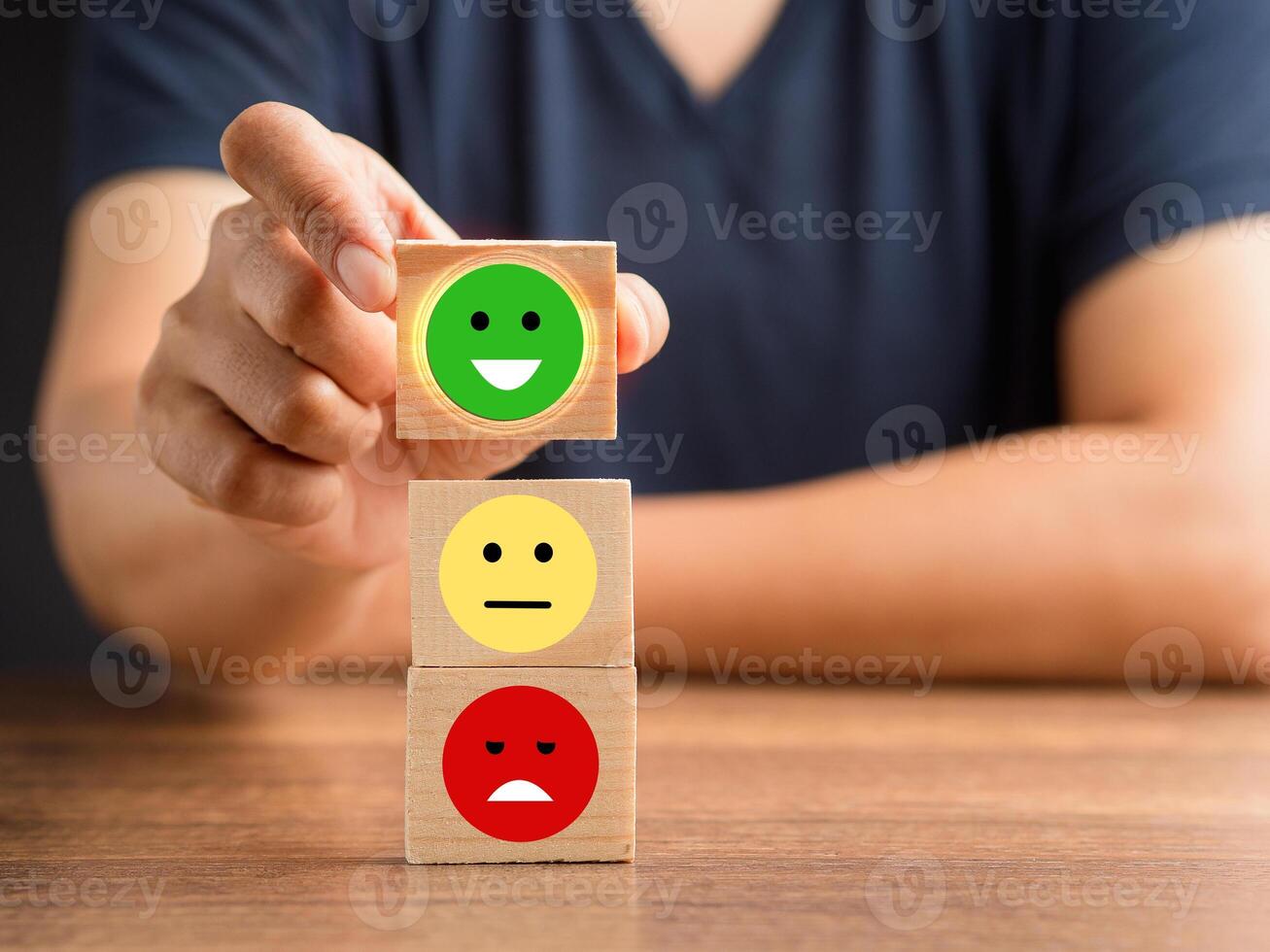 Good feedback rating and positive customer review. The client handpicked the happy face smile icon on the wooden cube over the table photo