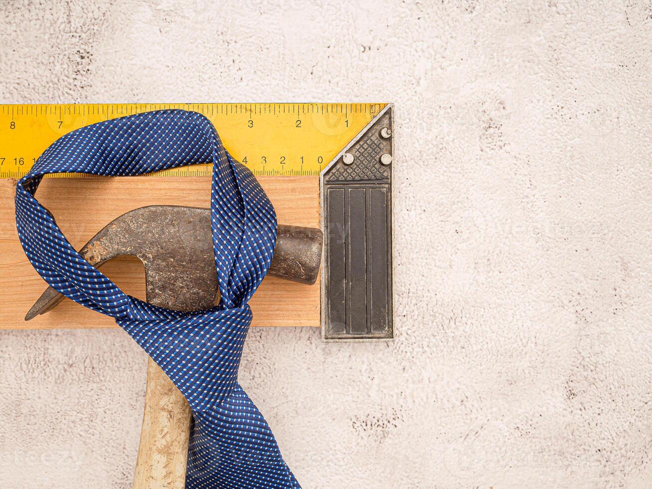 Happy Father's Day. Top view of construction handy tools and necktie over a cement floor photo