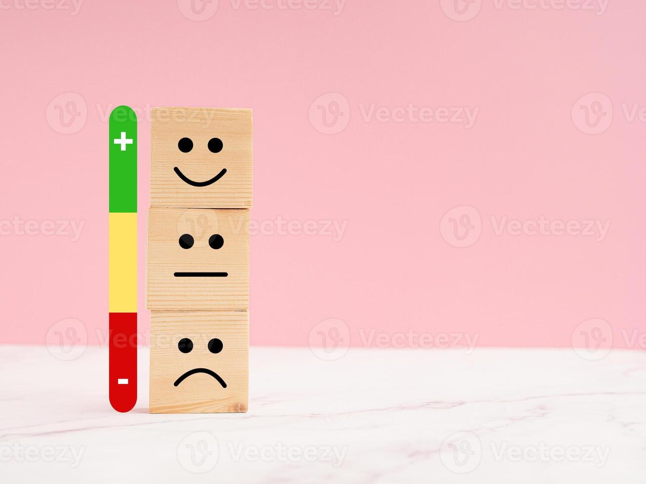 Customer experience, satisfaction, feedback, and services rating concept. Wooden cubes with sad and happy mood icons photo